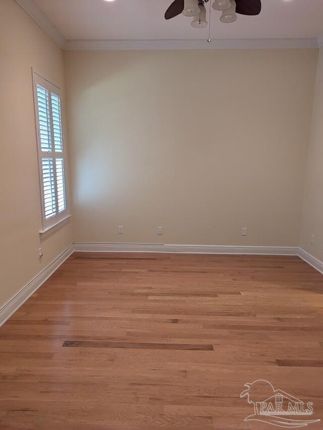 unfurnished room with ceiling fan, wood-type flooring, and ornamental molding