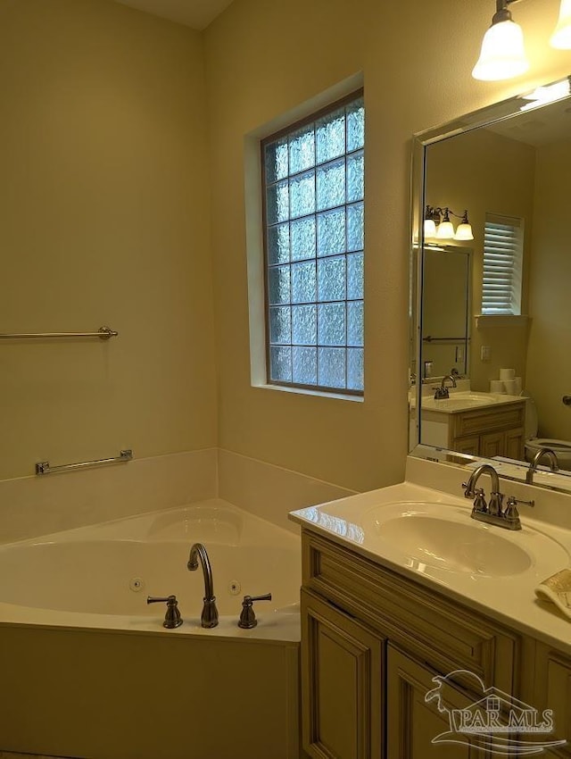 bathroom with vanity and a washtub