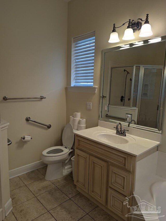 bathroom featuring vanity, toilet, and tile patterned flooring