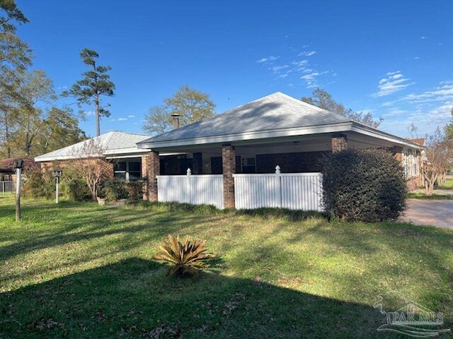 view of property exterior with a yard