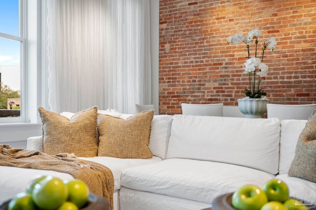 living room featuring brick wall
