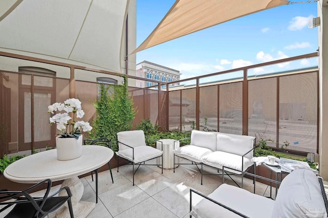 view of patio featuring a balcony and outdoor lounge area