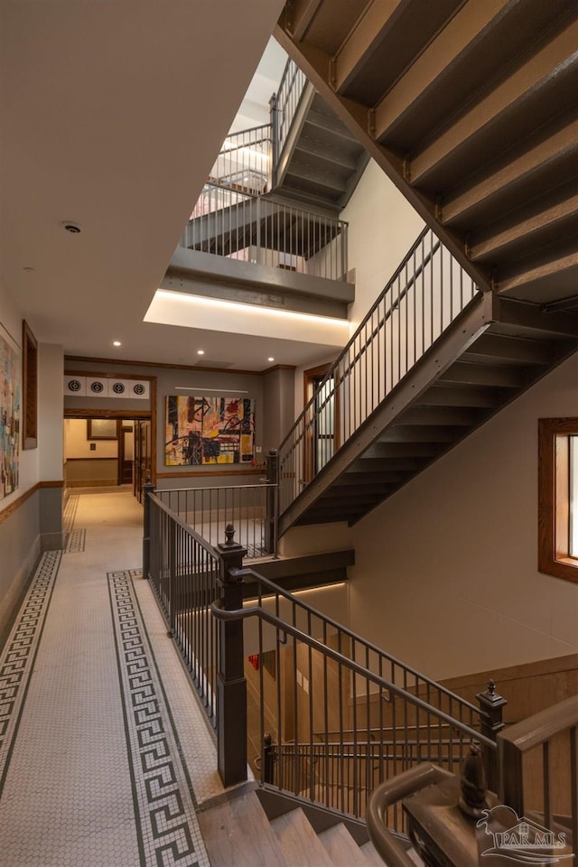 stairway with a high ceiling and baseboards