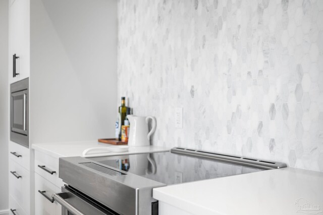interior space featuring stainless steel appliances, white cabinets, and light countertops