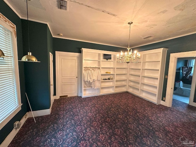 unfurnished dining area featuring a notable chandelier, a textured ceiling, dark carpet, and crown molding