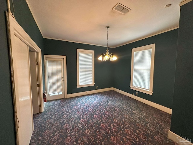 empty room featuring a notable chandelier, crown molding, and dark colored carpet