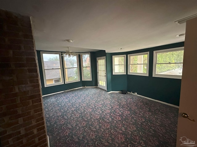 carpeted empty room featuring ceiling fan