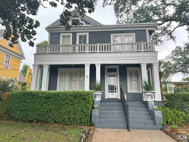 view of front of home featuring covered porch and a balcony