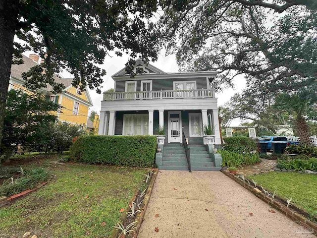 view of front of home featuring covered porch and a front lawn