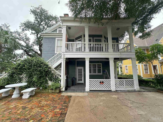 rear view of property with covered porch