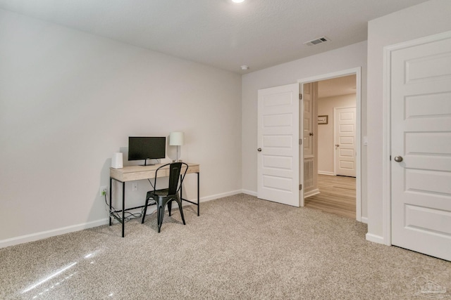 office space featuring baseboards, visible vents, and carpet flooring