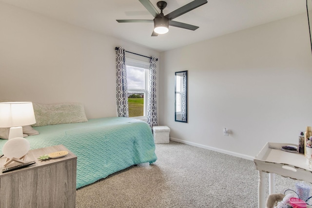 carpeted bedroom with ceiling fan and baseboards