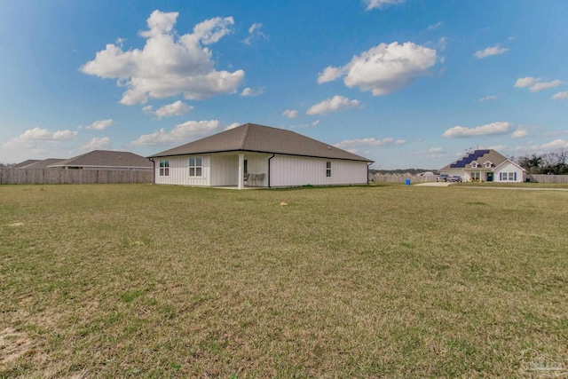 exterior space with a lawn and fence