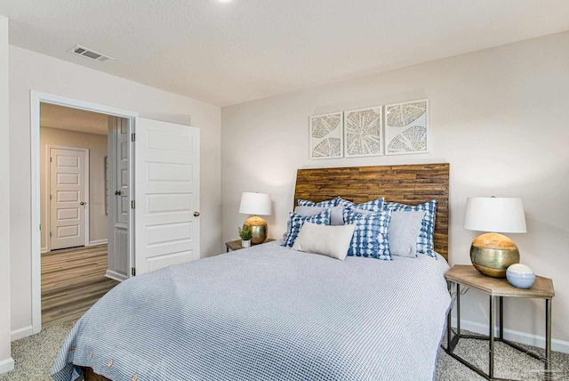 bedroom with hardwood / wood-style floors