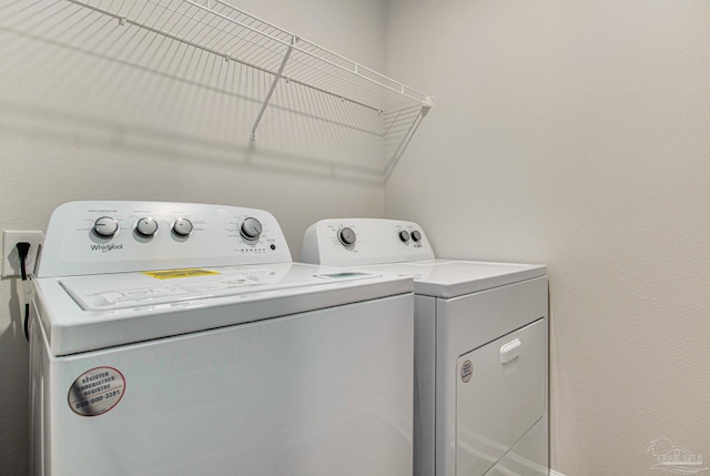 clothes washing area with separate washer and dryer