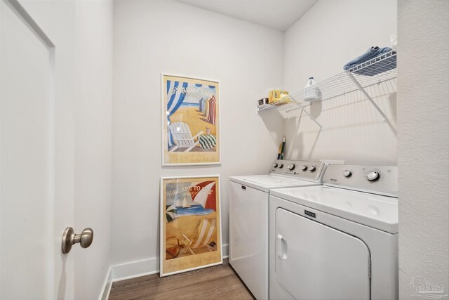 laundry room with dark hardwood / wood-style flooring and independent washer and dryer