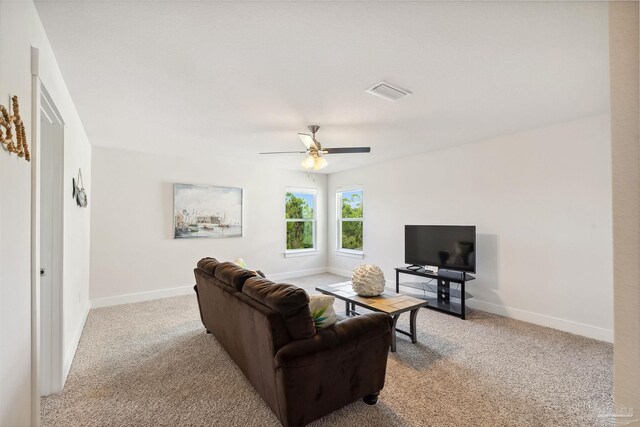 carpeted living room with ceiling fan