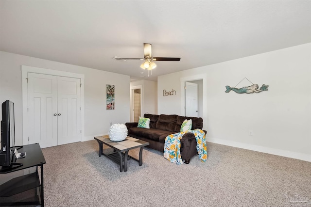 carpeted living room with ceiling fan