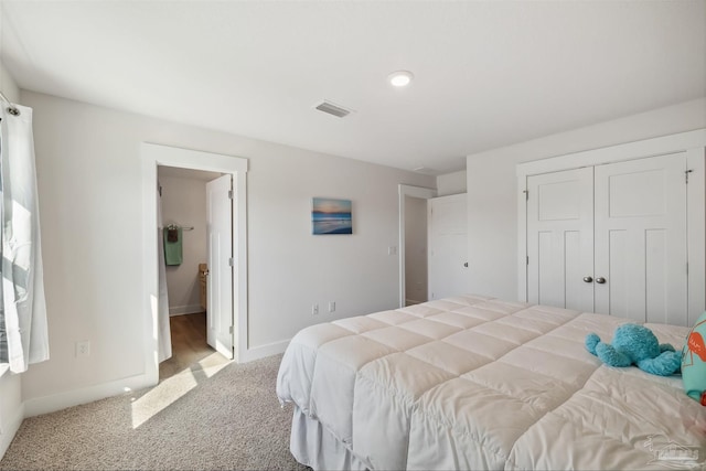 bedroom with light colored carpet and a closet