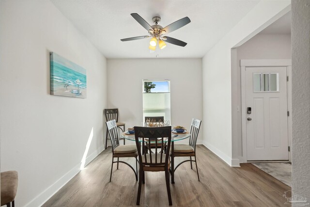 dining room with light wood-type flooring and ceiling fan