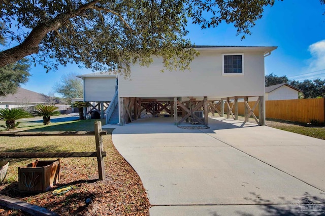 view of front facade with stairs, a carport, and driveway