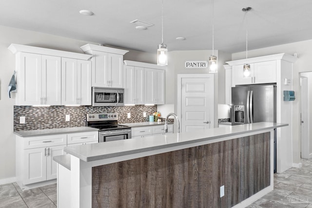 kitchen with tasteful backsplash, appliances with stainless steel finishes, marble finish floor, light countertops, and white cabinetry