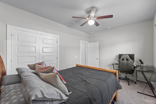 carpeted bedroom with ceiling fan, visible vents, and a closet