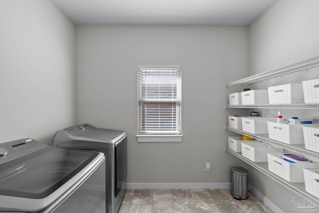 laundry area with washer and dryer, laundry area, and baseboards