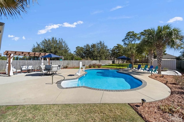 view of pool featuring an outbuilding, a fenced backyard, a fenced in pool, a storage unit, and a patio area