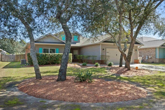 view of front of house with a garage, driveway, fence, cooling unit, and a front yard