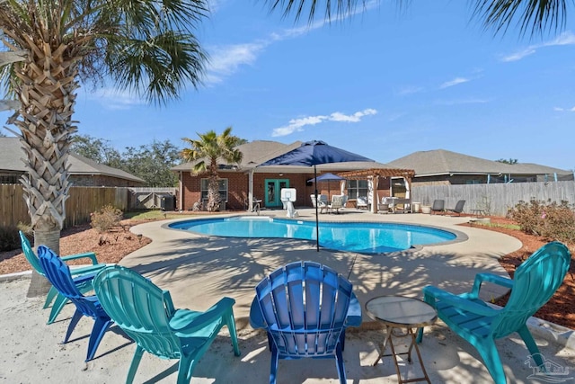 view of pool featuring an outbuilding, a patio area, a fenced backyard, and a fenced in pool