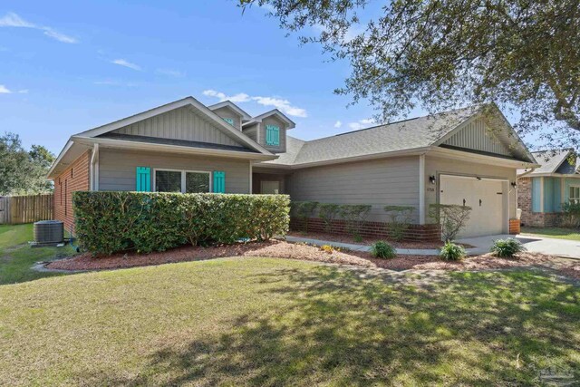 view of front of house featuring concrete driveway, a front yard, central AC, fence, and a garage