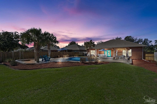 view of yard with a fenced in pool, a fenced backyard, and a patio