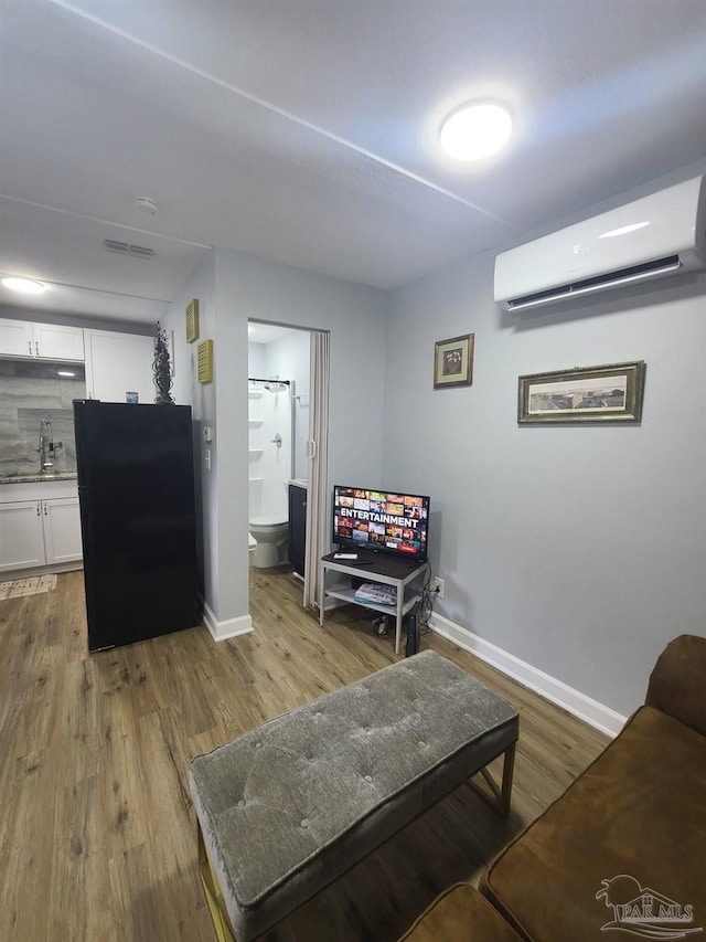 3111 Zepp Ln, Pace, FL 32571 - living area with an AC wall unit and wood finished floors