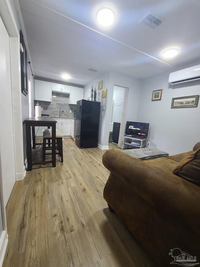 3111 Zepp Ln, Pace, FL 32571 - living room with a wall unit AC and light wood finished floors