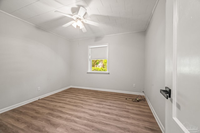 spare room with baseboards, a ceiling fan, and wood finished floors