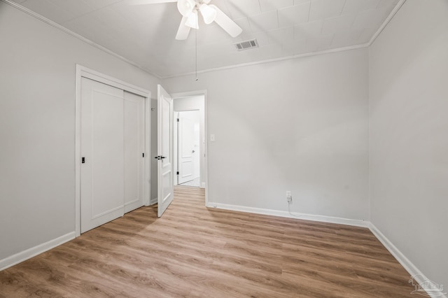 unfurnished bedroom with light wood finished floors, visible vents, and baseboards