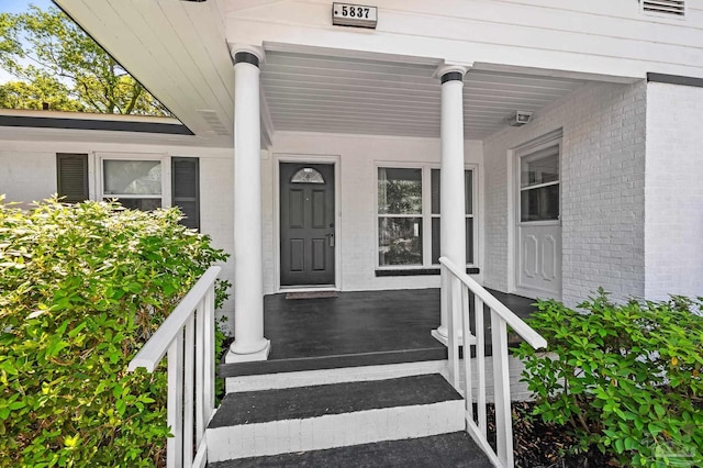 view of exterior entry with brick siding