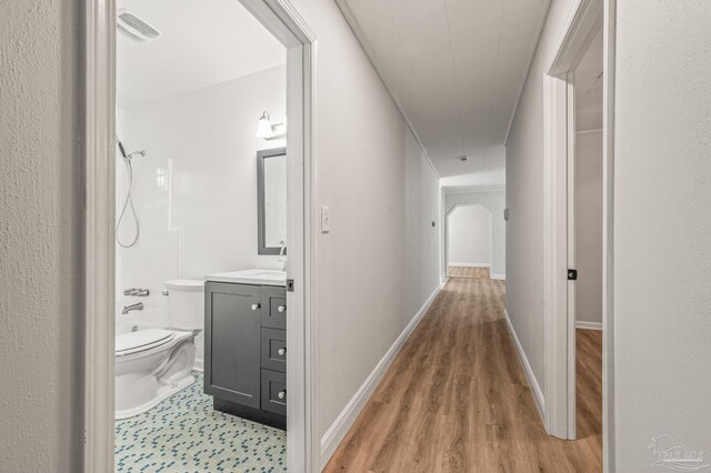 hall with visible vents and baseboards