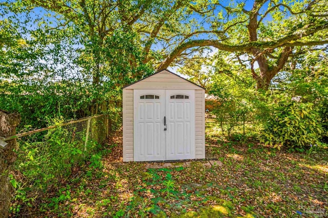 view of shed with fence