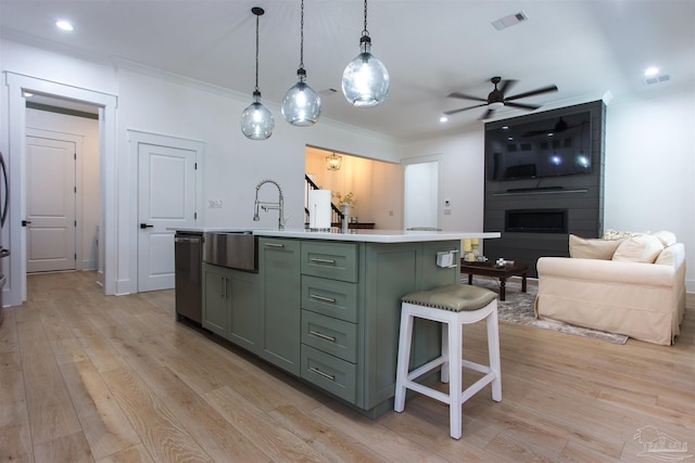 kitchen featuring visible vents, light countertops, dishwasher, light wood-style floors, and green cabinets