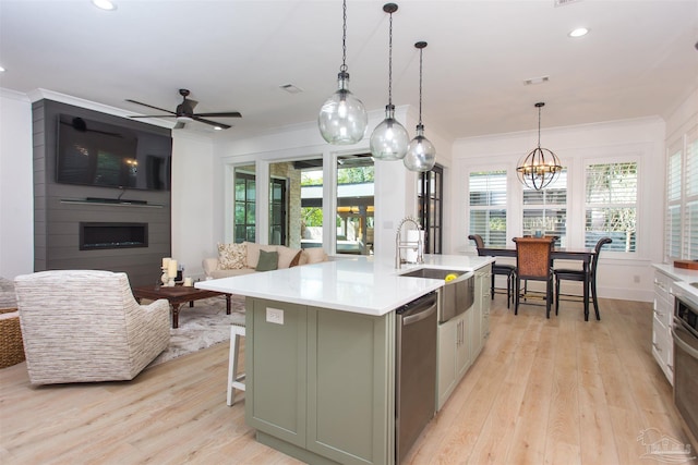 kitchen with a sink, dishwasher, ornamental molding, and light countertops