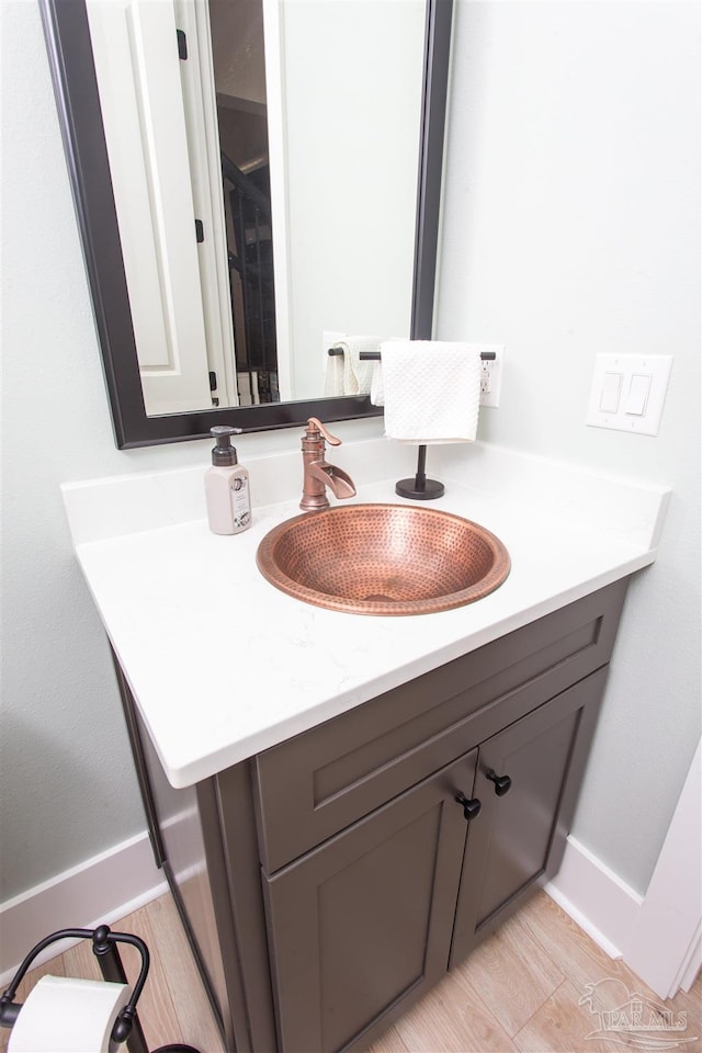 bathroom featuring baseboards and vanity