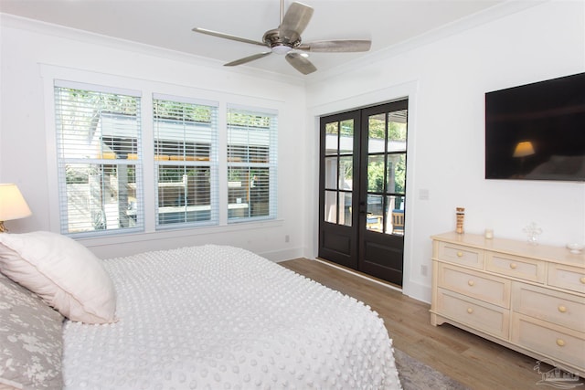 bedroom featuring baseboards, ornamental molding, access to exterior, french doors, and light wood-style floors