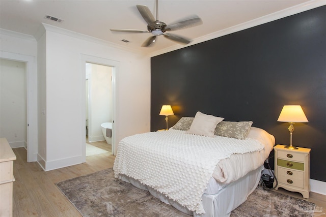 bedroom with visible vents, ornamental molding, baseboards, and wood finished floors