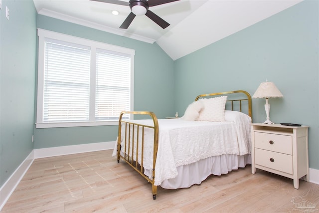 bedroom featuring a ceiling fan, lofted ceiling, wood finished floors, and baseboards