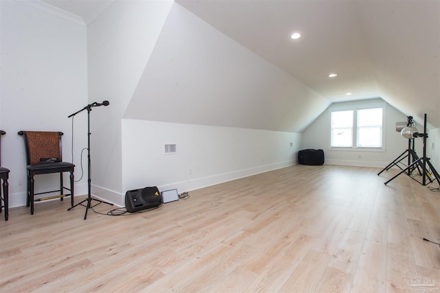 bonus room with visible vents, baseboards, wood finished floors, and vaulted ceiling