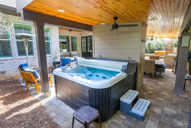 view of patio / terrace with area for grilling, ceiling fan, and a hot tub