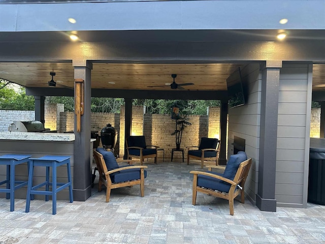 view of patio featuring area for grilling, an outdoor bar, ceiling fan, and fence