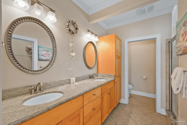 bathroom with toilet, vanity, crown molding, and tile patterned flooring